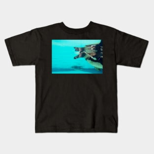 Cute penguin swimming in crystal blue water Kids T-Shirt